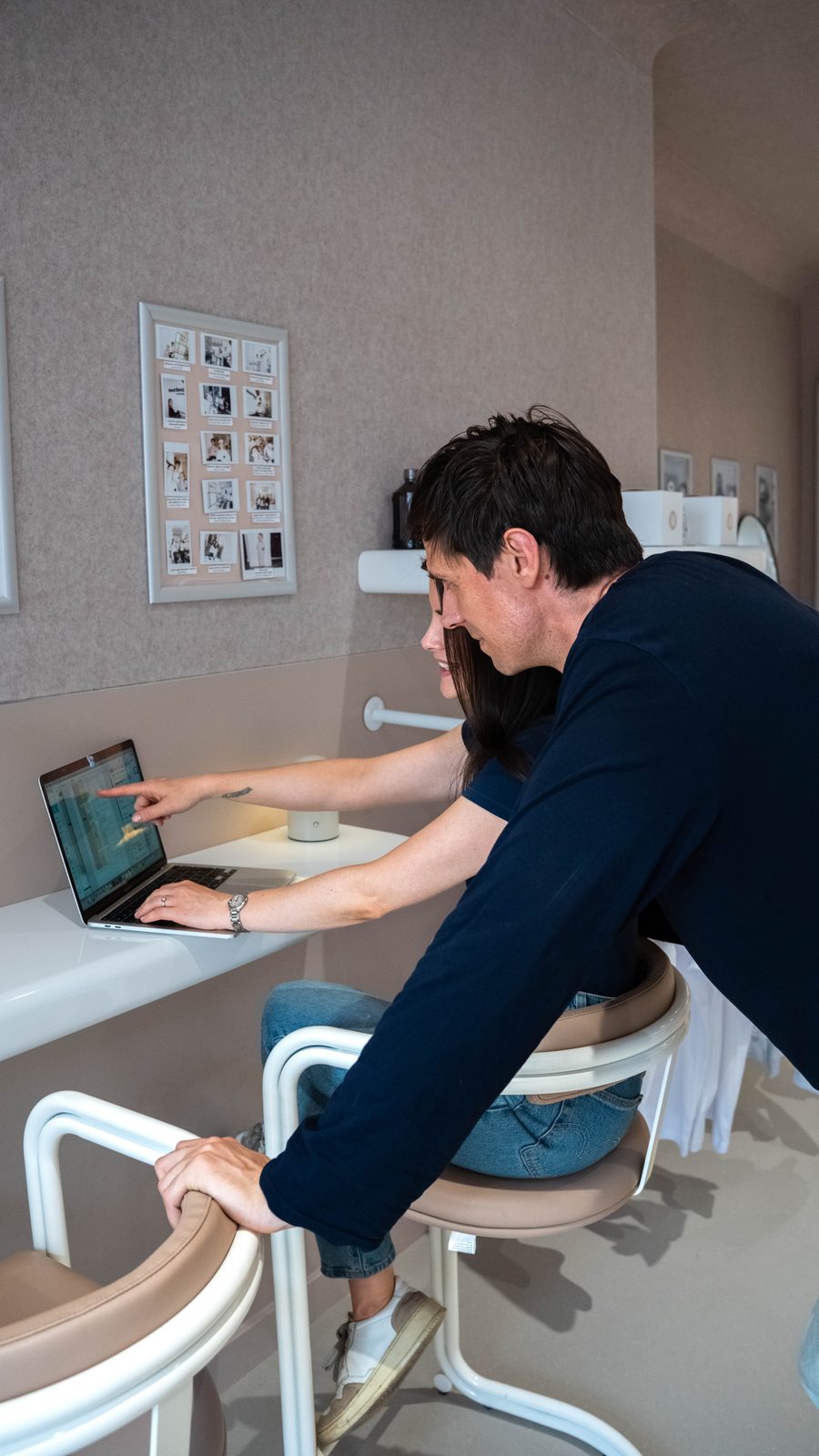 Two founders reviewing work on a laptop in the Good Bear café