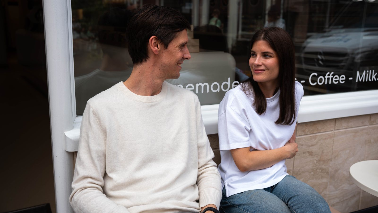 Two founders chatting outside the shop window