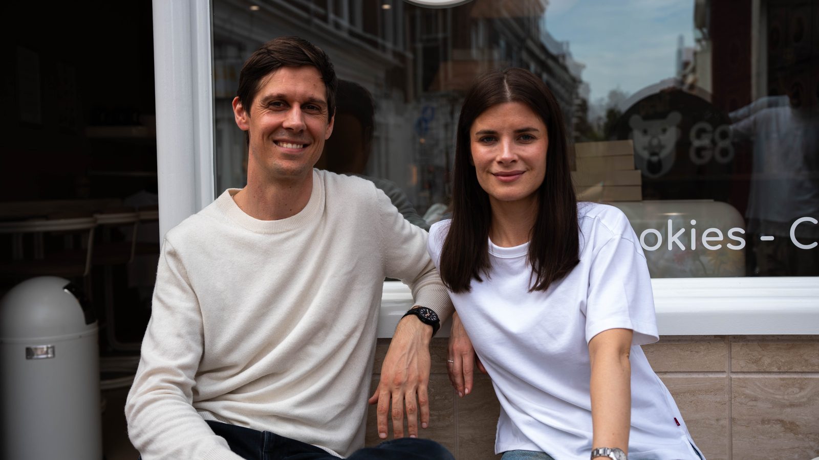 Two founders smiling outside the shop